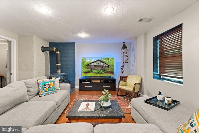 11713 Henderson Rd, Clifton, VA 20124 - living room featuring a wood stove, a textured ceiling, and recessed lighting