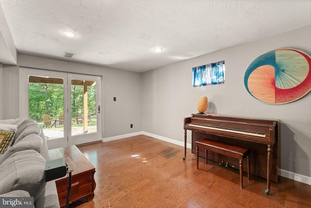 11713 Henderson Rd, Clifton, VA 20124 - living area with a textured ceiling, baseboards, wood finished floors, and recessed lighting