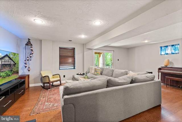 11713 Henderson Rd, Clifton, VA 20124 - living room featuring a textured ceiling, wood finished floors, recessed lighting, and baseboards