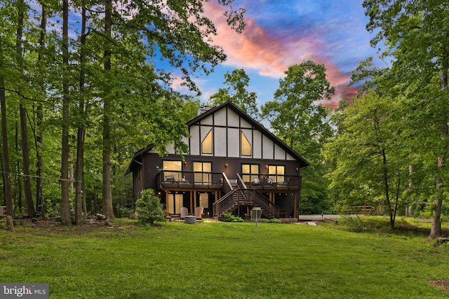 11713 Henderson Rd, Clifton, VA 20124 - back of property at dusk with a wooden deck, stairs, and a yard