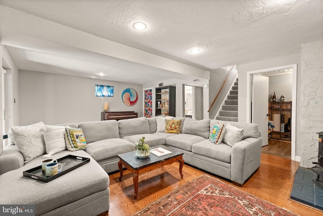 11713 Henderson Rd, Clifton, VA 20124 - living area with wood finished floors, a textured ceiling, stairway, and recessed lighting