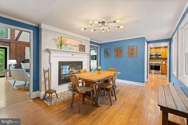 11713 Henderson Rd, Clifton, VA 20124 - dining room with light wood-type flooring, a glass covered fireplace, crown molding, baseboards, and a chandelier