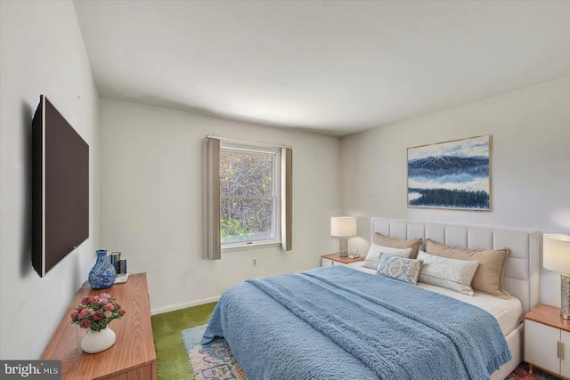 carpeted bedroom featuring baseboards