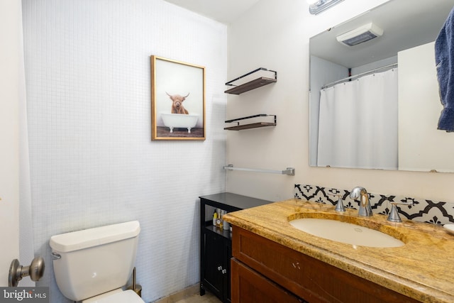 full bathroom with visible vents, toilet, and vanity