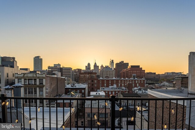 balcony at dusk with a view of city