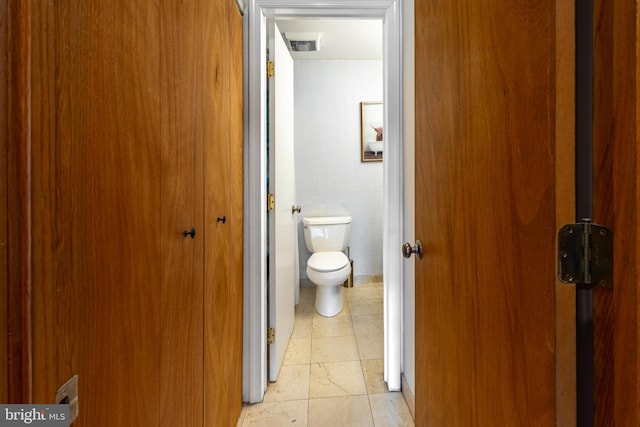 bathroom with toilet, tile patterned flooring, and visible vents