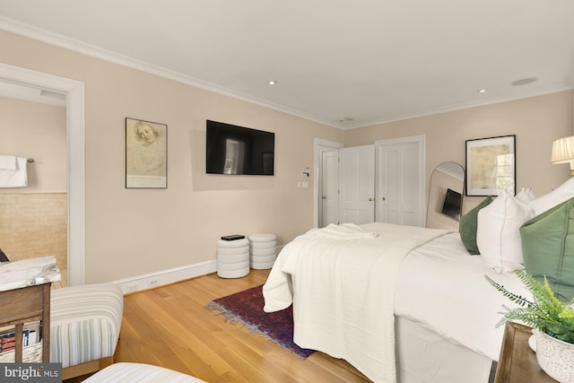 bedroom with recessed lighting, baseboards, ornamental molding, and wood finished floors