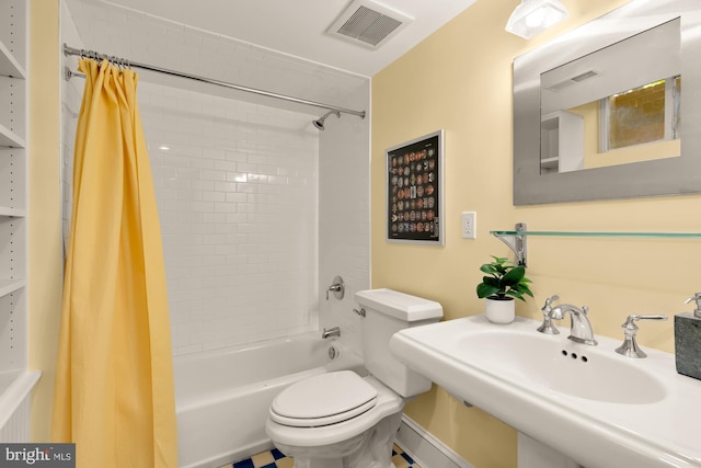 bathroom with visible vents, a sink, shower / bath combo, and toilet
