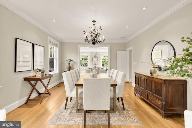 dining room with a chandelier, light wood-style flooring, recessed lighting, baseboards, and ornamental molding