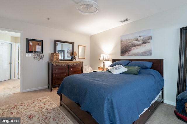 bedroom with baseboards, visible vents, and carpet