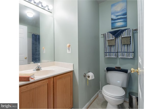 full bath with toilet, baseboards, tile patterned floors, and vanity