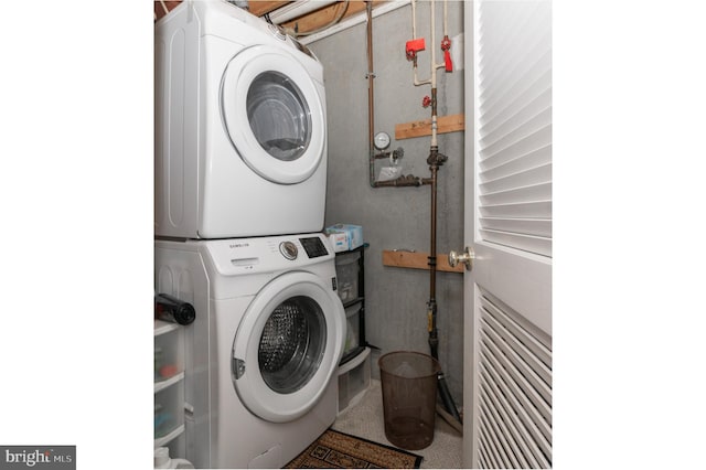 clothes washing area with laundry area and stacked washer / drying machine