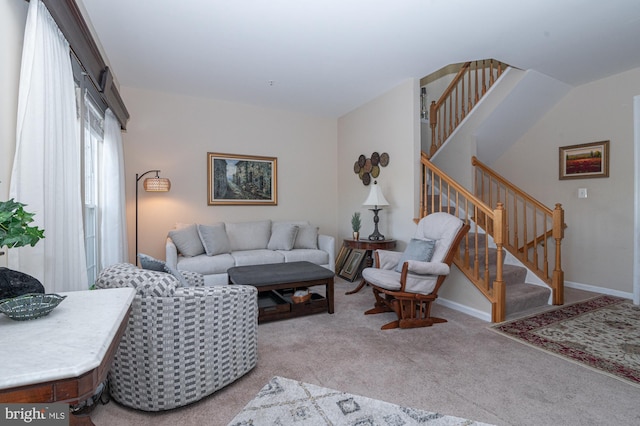 living room featuring stairs, baseboards, and carpet