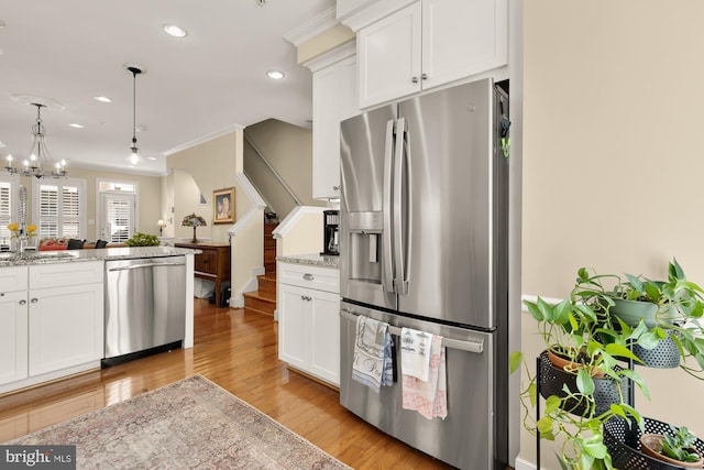kitchen with a sink, appliances with stainless steel finishes, recessed lighting, white cabinets, and light wood-style floors