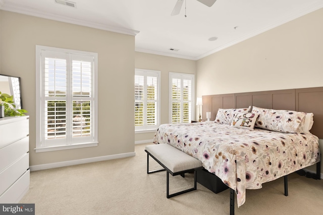 bedroom with light colored carpet, visible vents, crown molding, a ceiling fan, and baseboards