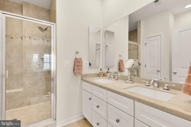full bath with a stall shower, visible vents, a sink, and double vanity