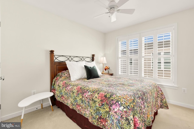 carpeted bedroom featuring baseboards and a ceiling fan