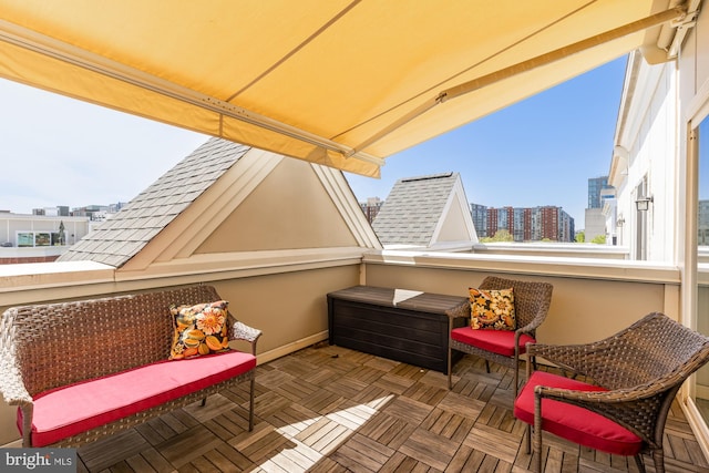 view of patio / terrace with a balcony and a view of city