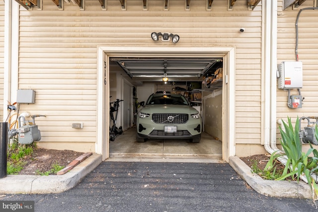 garage featuring aphalt driveway