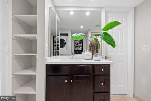 bathroom with recessed lighting, tile patterned floors, vanity, visible vents, and stacked washer and clothes dryer