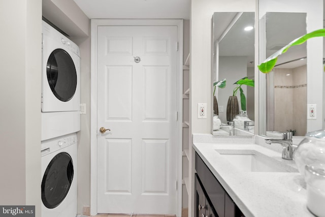 bathroom with stacked washer / drying machine and vanity