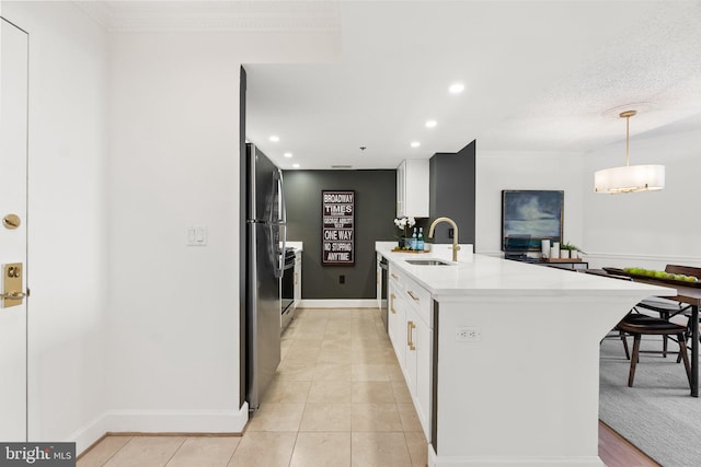 kitchen featuring white cabinets, a sink, light countertops, baseboards, and recessed lighting