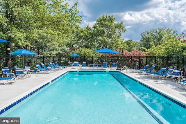 pool featuring fence and a patio area