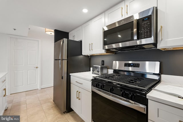kitchen featuring white cabinets, light tile patterned floors, appliances with stainless steel finishes, and recessed lighting