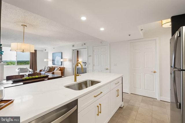 kitchen with white cabinets, a sink, stainless steel appliances, open floor plan, and recessed lighting