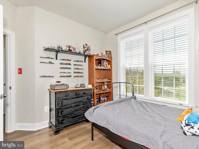 bedroom featuring baseboards and light wood-style floors