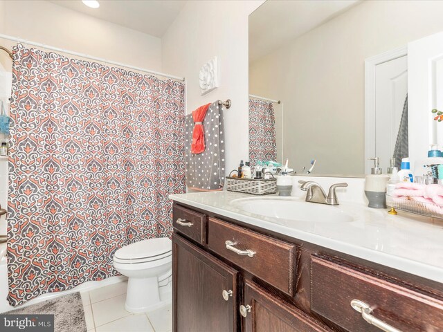 bathroom with vanity, tile patterned flooring, a shower with shower curtain, and toilet