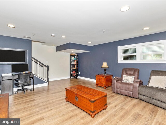 living area with recessed lighting, stairs, wood finished floors, and baseboards