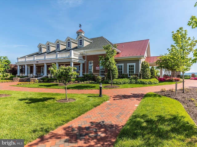 new england style home with a front lawn