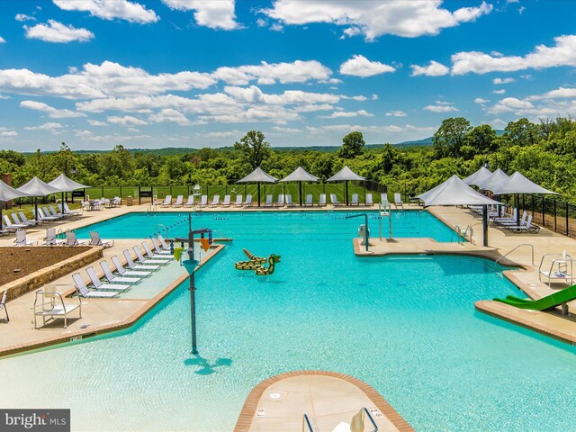 pool with fence and a patio area