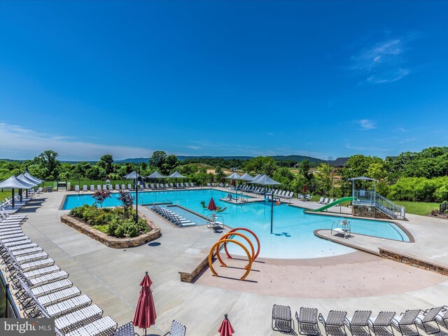 community pool featuring a patio and fence