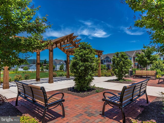 surrounding community featuring a pergola, a residential view, and a patio