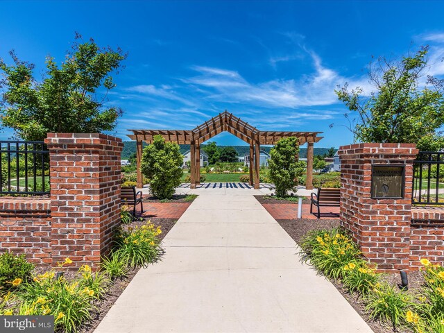 view of home's community featuring fence and a pergola