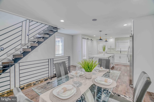 2832 Edgemont St, Philadelphia, PA 19134 - dining room with light wood-type flooring, recessed lighting, stairs, and a barn door