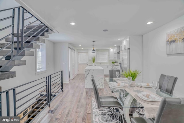 2832 Edgemont St, Philadelphia, PA 19134 - dining space featuring light wood finished floors, baseboards, recessed lighting, and stairs