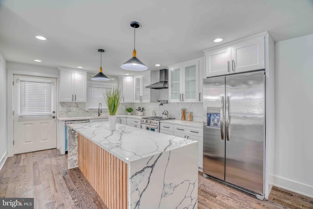 2832 Edgemont St, Philadelphia, PA 19134 - kitchen featuring white cabinets, wall chimney exhaust hood, appliances with stainless steel finishes, and backsplash