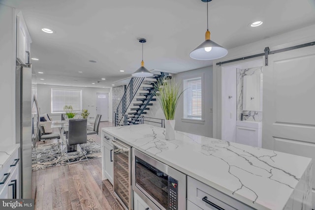 2832 Edgemont St, Philadelphia, PA 19134 - bar featuring recessed lighting, beverage cooler, light wood finished floors, and appliances with stainless steel finishes