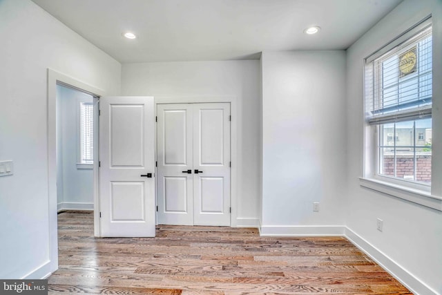 2832 Edgemont St, Philadelphia, PA 19134 - unfurnished bedroom with baseboards, multiple windows, light wood finished floors, and a closet