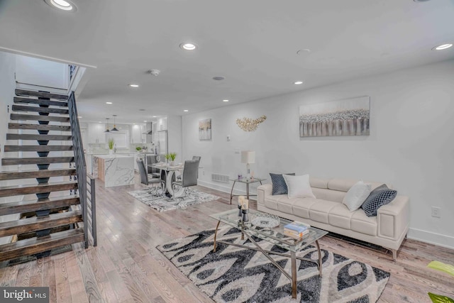 2832 Edgemont St, Philadelphia, PA 19134 - living room with light wood-type flooring, baseboards, stairway, and visible vents