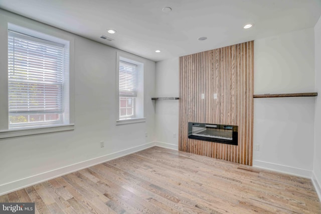 2832 Edgemont St, Philadelphia, PA 19134 - unfurnished living room featuring baseboards, a glass covered fireplace, wood finished floors, and visible vents