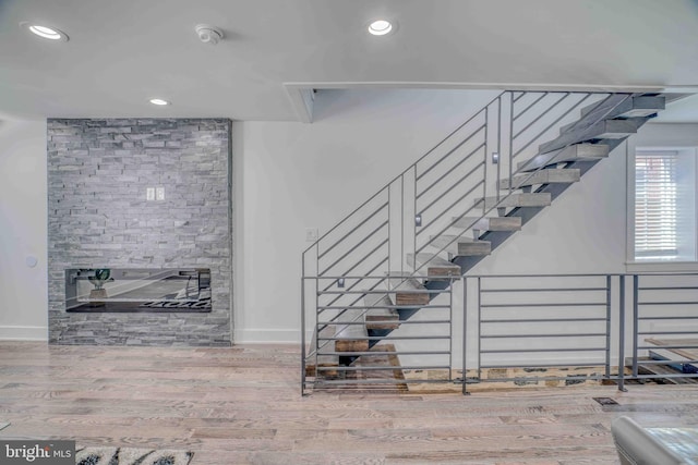 2832 Edgemont St, Philadelphia, PA 19134 - staircase featuring recessed lighting, wood finished floors, baseboards, and a stone fireplace