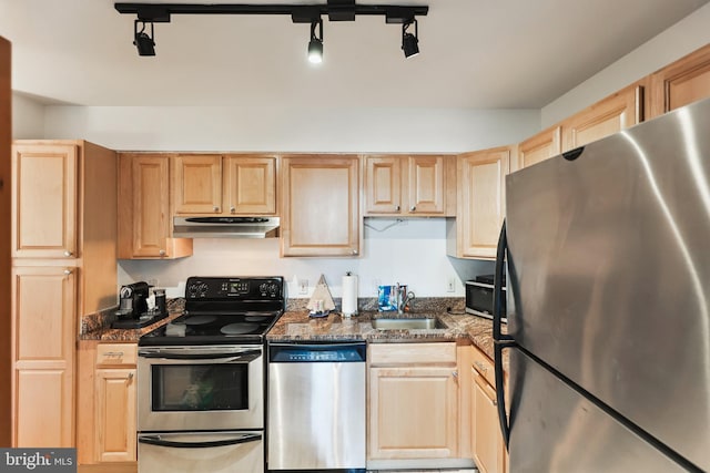 2141 P St NW Unit 1010, Washington, DC 20037 - kitchen featuring appliances with stainless steel finishes, a sink, light brown cabinets, dark stone countertops, and under cabinet range hood