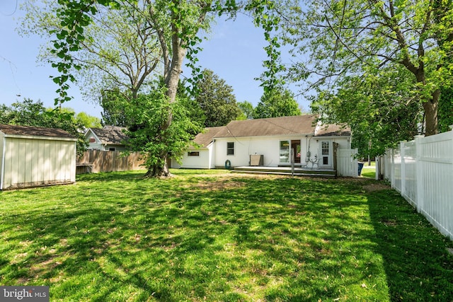 103 W Marengo, Saint Michaels, MD 21663 - back of property featuring a lawn, a fenced backyard, and a shed