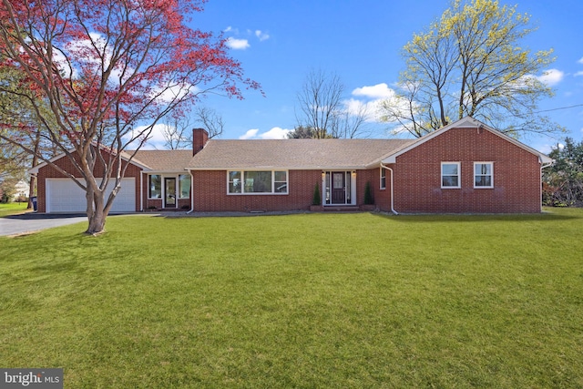 ranch-style home with an attached garage, a front lawn, aphalt driveway, brick siding, and a chimney