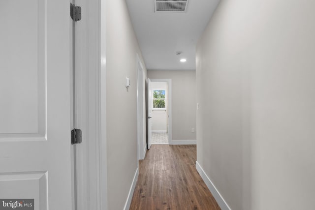 hall featuring recessed lighting, baseboards, visible vents, and dark wood-type flooring