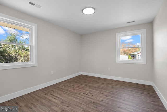 unfurnished room featuring baseboards, plenty of natural light, and visible vents
